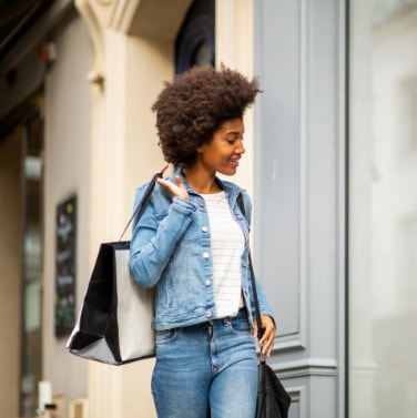 Woman with shopping bag walking in Charlottesville Fashion Square